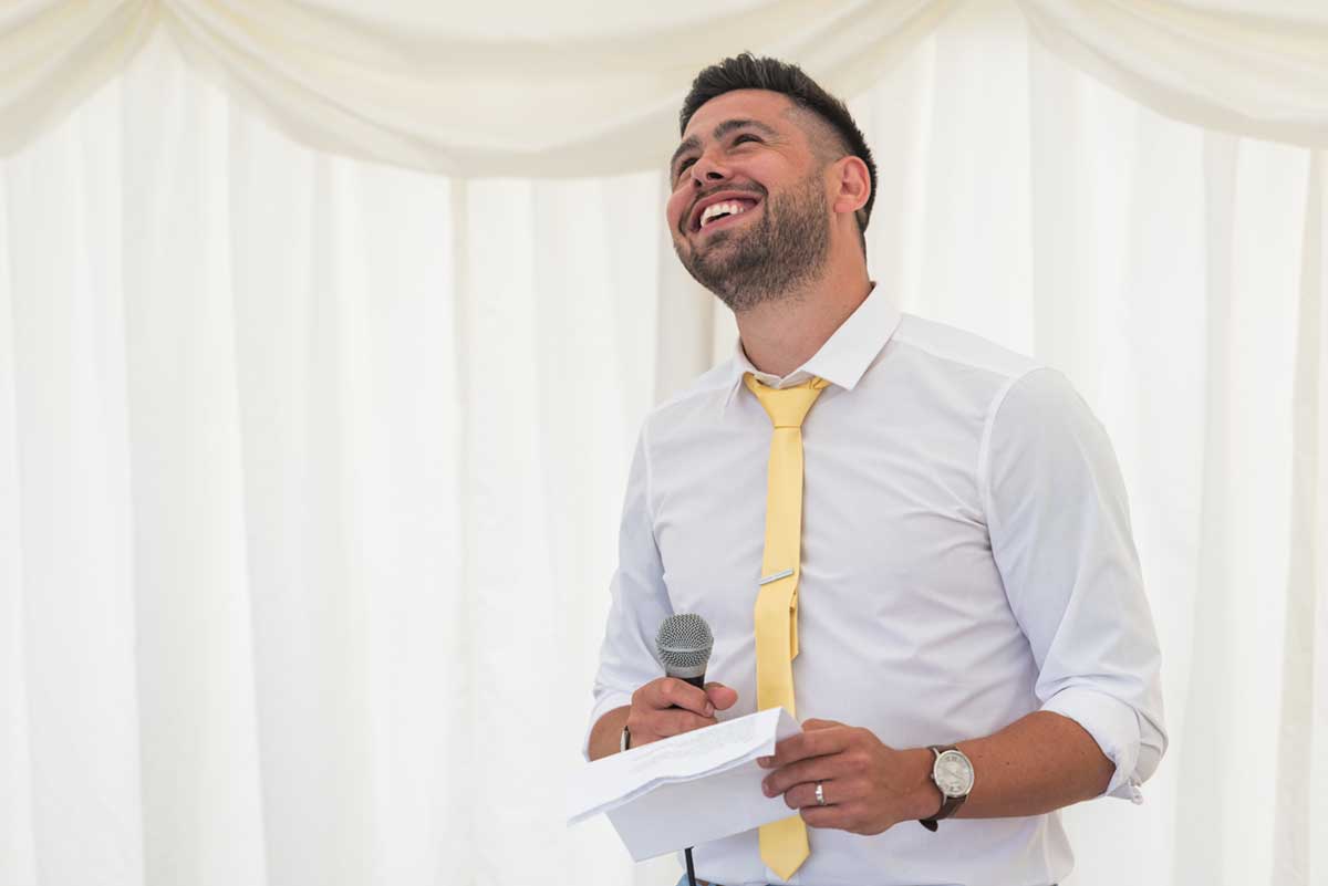 Burloes Hall wedding speech under a marquee